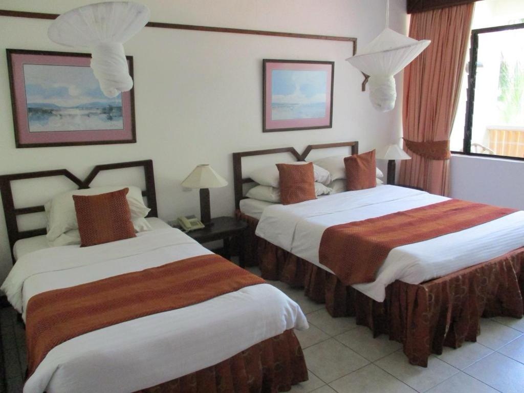 Twin hotel room with garden view at a partner property