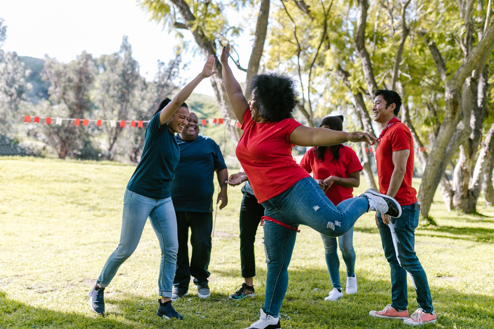 Large team celebrating outdoors at a team-building event