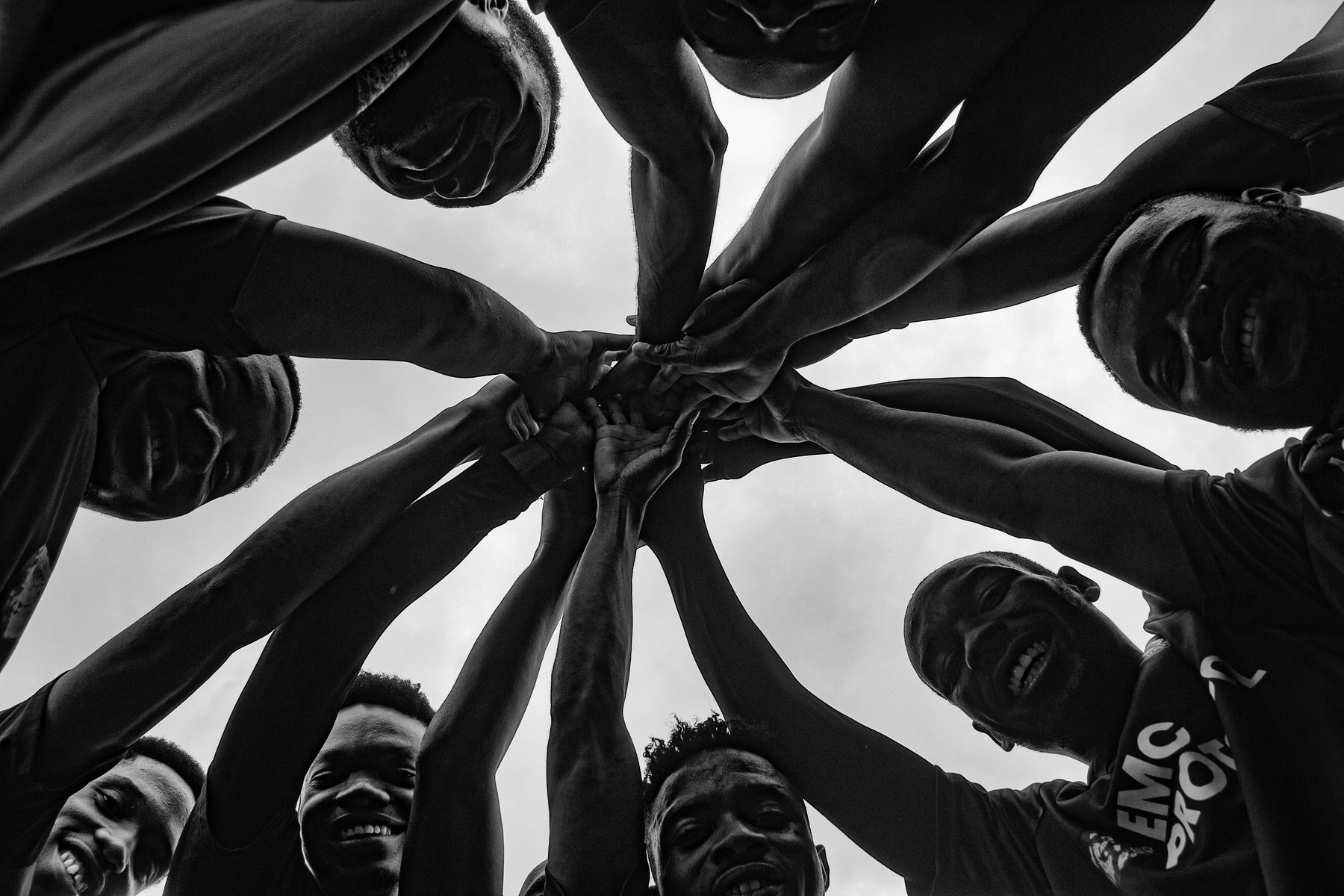 Team stacking hands together in a huddle